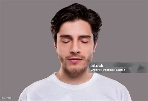 Portrait Of Handsome Millennial Man With Closed Eyes Stock Photo