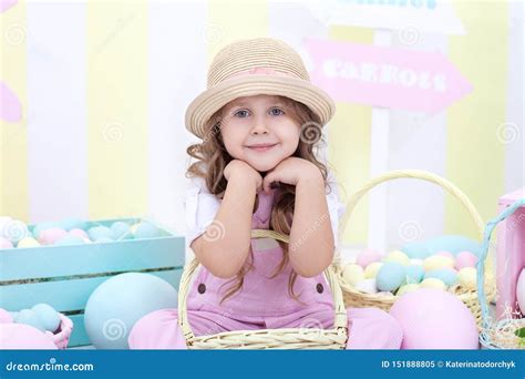 Easter A Girl Holds A Basket Of Eggs On The Background Of Easter