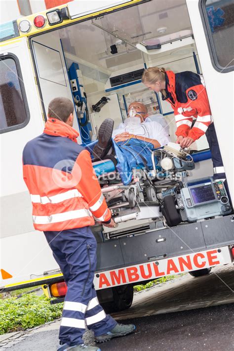 Paramedics Putting Patient Man Oxygen Mask In Ambulance Car Royalty