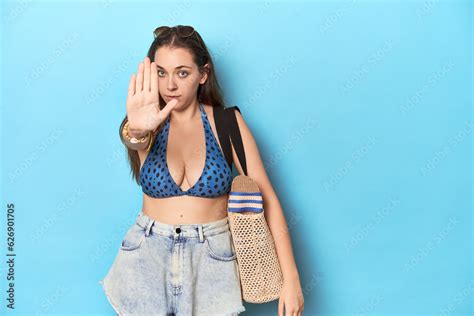 Beach Ready Woman With Bikini Sunglasses And Bag Standing With Outstretched Hand Showing Stop