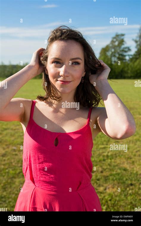 Smiling Brunette Portrait With Green Grass Background Stock Photo Alamy