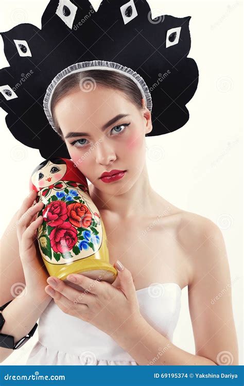 Woman With Blond Hair In Russian National Hat Holding Matrioshka Doll