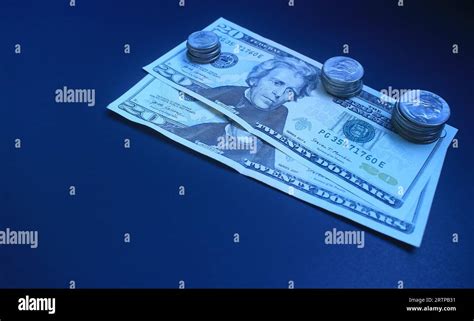 20 dollar bills with coins Stock Photo - Alamy