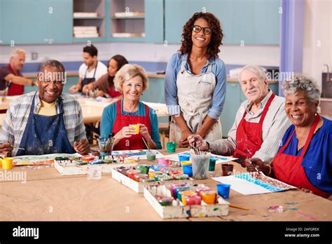 Portrait Of Retired Seniors Attending Art Class In Community Centre