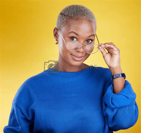 Face, black woman and glasses for vision, fashion and casual outfit against a studio background ...