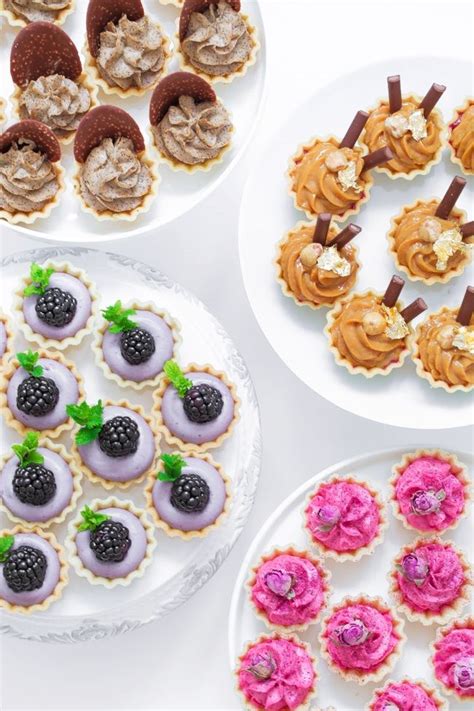 Three Plates Filled With Desserts On Top Of A White Table