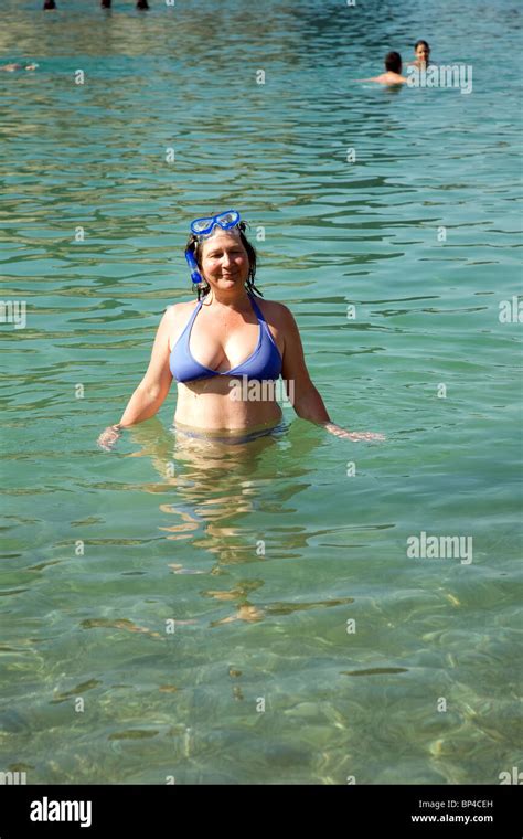 Middle Aged Woman In Bikini Standing In Sea Stock Photo Alamy