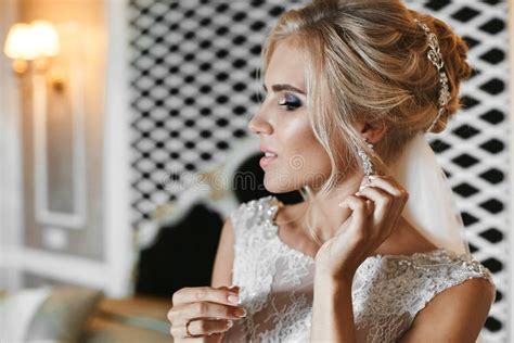 Beautiful And Elegant Blonde Model Girl With Bright Make Up And Stylish Wedding Hairstyle In