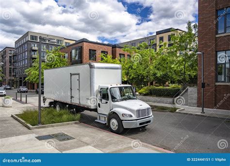 Day Cab Middle Duty Rig Semi Truck With Box Trailer Making Delivery Standing On The Urban Street