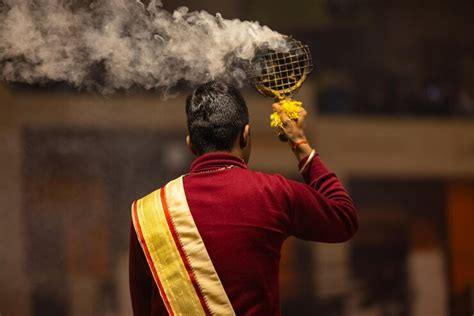 Premium Photo | Ganga aarti Portrait of young priest performing holy ...