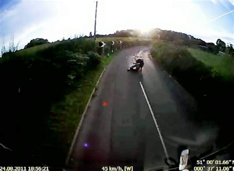 Moment Motorcyclist Survives Crashing Into Lorry After Hitting Pothole