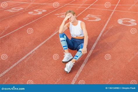 Tired Woman Runner Taking A Rest After Run Sitting On The Running Stock