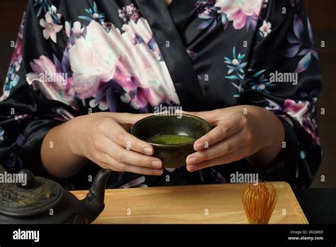 Woman Tea Master In Kimono Performs Tea Ceremony Matcha Green Tea Powder With A Bamboo Whisk