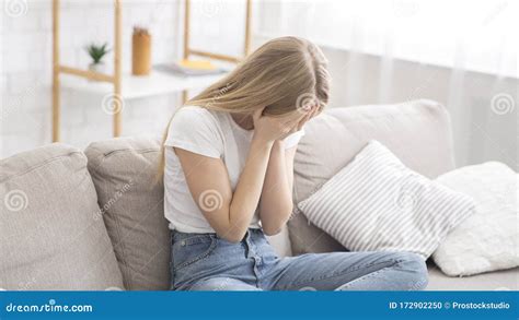 Desperate Young Woman Crying On Couch At Home Stock Photo Image Of