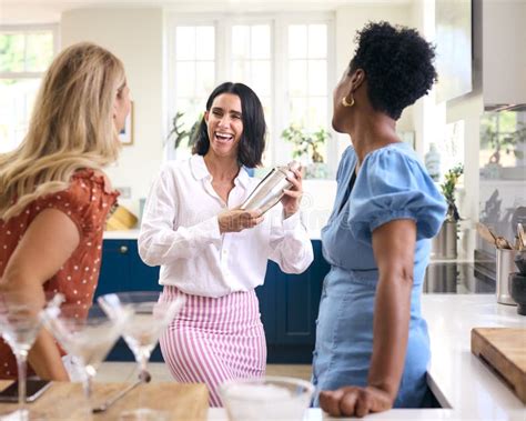Three Mature Female Friends At Home Having Fun Mixing Cocktails Together Stock Image Image Of