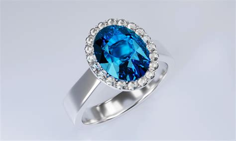 The Large Oval Blue Diamond Is Surrounded By Many Diamonds On The Ring