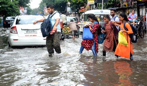 Kolkata People Wade Through Waterlogged Street After Heavy Rainfall