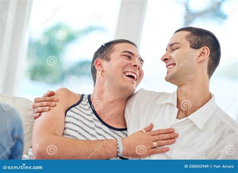 Our Home Is Filled With Love And Laughter Shot Of A Gay Couple Relaxing Together At Home Stock