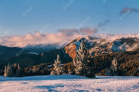 Premium Photo | A snowy mountain landscape with a mountain in the background.