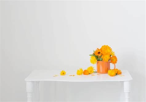 Premium Photo | Bouquet with orange marigolds in cup on white background