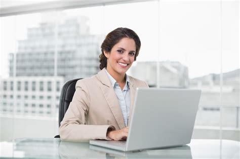 Premium Photo Happy Businesswoman Typing On Laptop At Her Desk