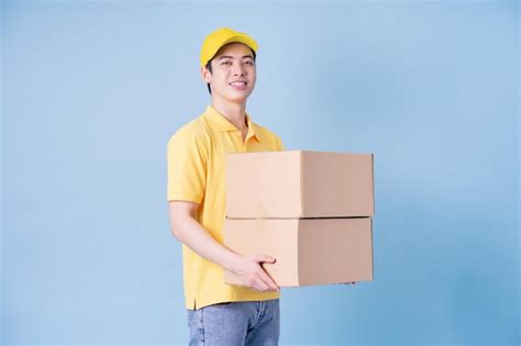 Premium Photo | Image of young Asian delivery man on blue background