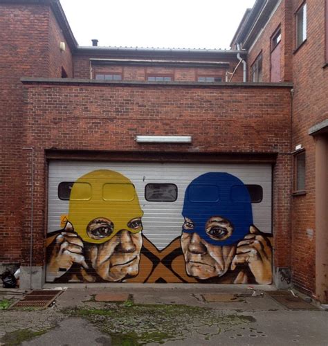 Two Men Painted On The Side Of A Garage Door