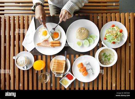 Closeup Of Woman Hands Holding Knife And Fork During Eating Breakfast