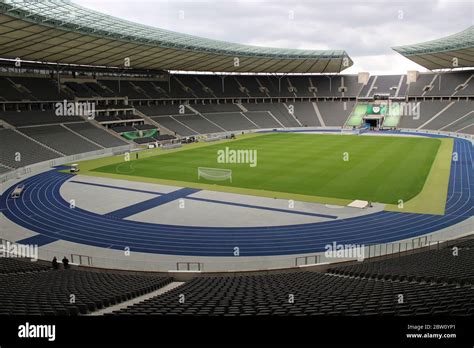 The Football Pitch And Blue Athletics Running Track Of The Berlin