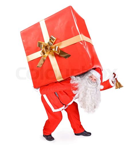 Santa Claus trägt ein großes Geschenk Stock Bild Colourbox