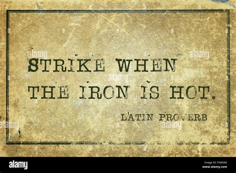 Strike When The Iron Is Hot Ancient Latin Proverb Printed On Grunge Vintage Cardboard Stock