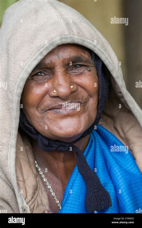 Portrait of an old toothless woman smiling at a foodstall near Munnar ...