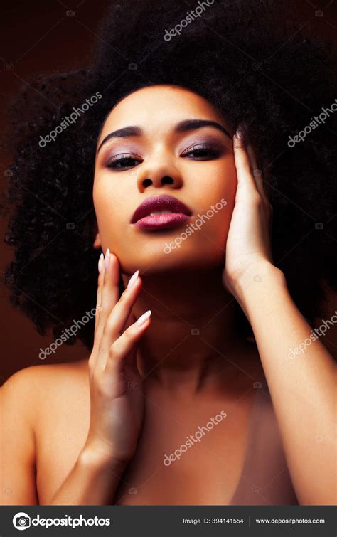 Pretty Young African American Woman With Curly Hair Posing Cheerful