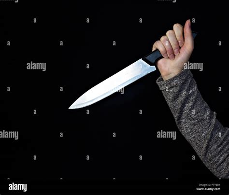 Hand Of A Girl With A Knife On A Black Background Close Up Knife