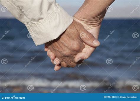 Senior Couple Holding Hands on the Beach Stock Photo - Image of hands, female: 22040470