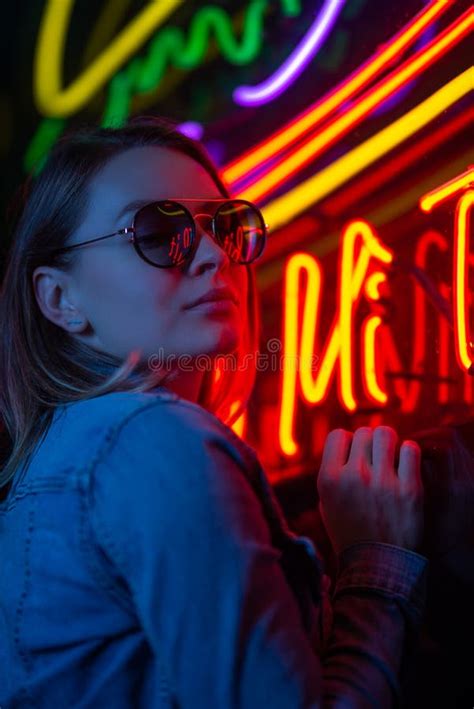 Creative Portrait Of A Girl In Neon Lighting With Glasses Stock Image