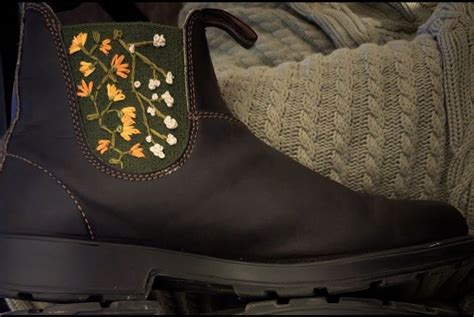 Black Blundstone Boot With Green Side Panel Up One Side White Flowers