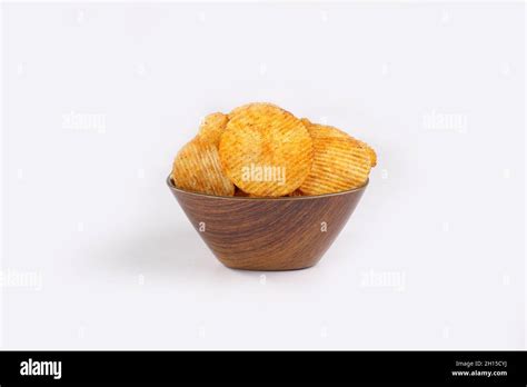 Potato Chips Falling Into Glass Bowl Isolated On White Background With