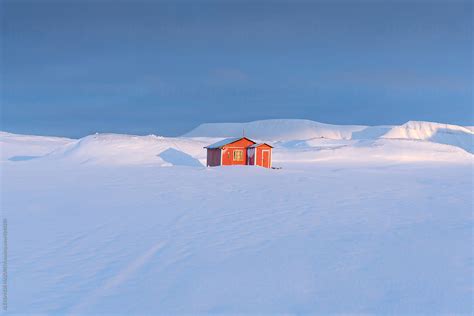 "Red Cabin In The Winter" by Stocksy Contributor "Alex Mazurov" - Stocksy