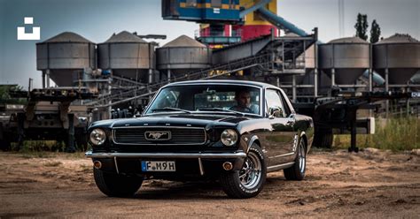 Black Ford Mustang near factory photo – Free Car Image on Unsplash