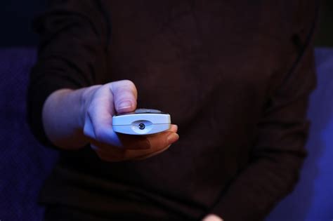 Premium Photo Woman Hand Holding A Tv Remote Control On Dark Background