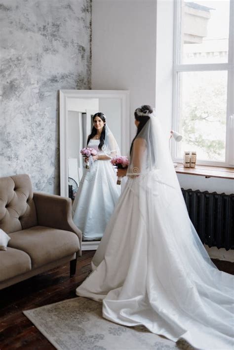 Brunette Bride In A Tight Wedding Dress In A Studio Stock Photo Image Of Brunette Bouquet