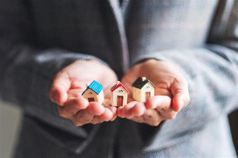 Premium Photo Closeup Image Of People Holding House Models In Hands