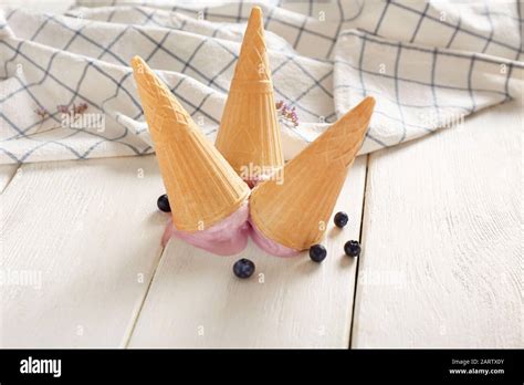 Wafer Cones With Tasty Blueberry Ice Cream On White Table Stock Photo