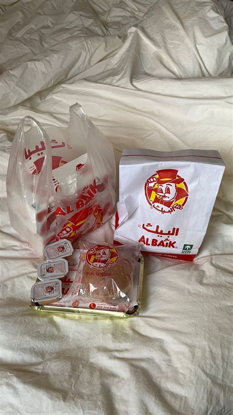 Some Food Is Laying Out On A Bed With White Sheets And Plastic Bags