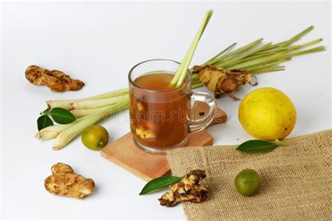 Hot Red Ginger Drink In A Glass Cup With Some Raw Ginger And Lemon Stock Photo Image Of Liquid