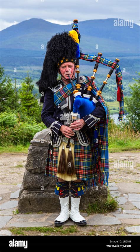 Traditional Scottish Piper Playing The Bagpipes At The Glen Garry