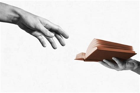 Two Hands Reaching For Each Other Over A Book