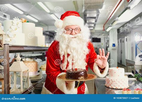 Santa Claus A Confectioner Cooks A Cake In The Kitchen On Christ Stock