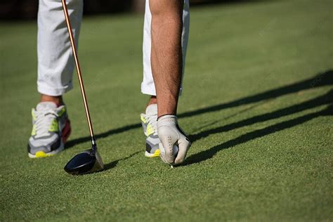 Golf Player Placing Ball On Tee Hand Game Club Photo Background And